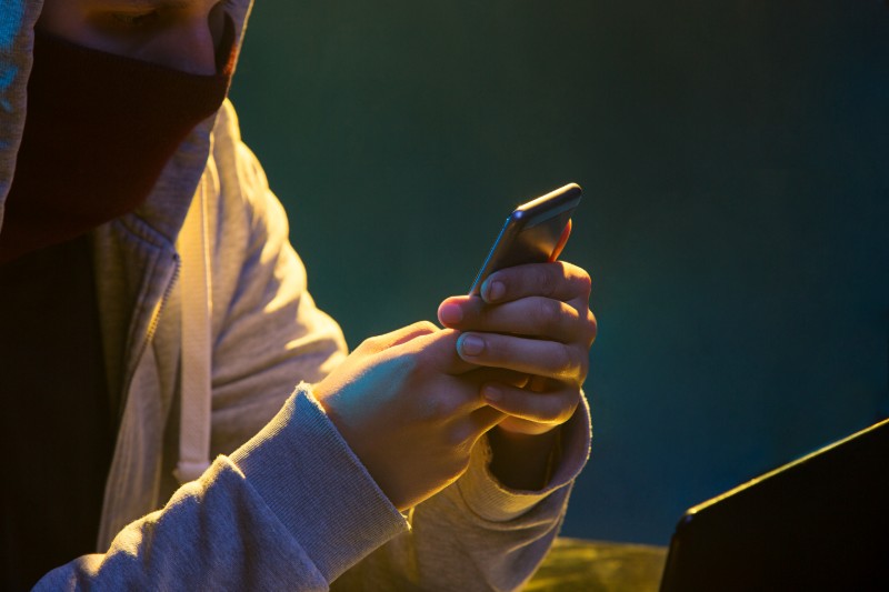 hooded-computer-hacker-stealing-information-with-laptop (1)